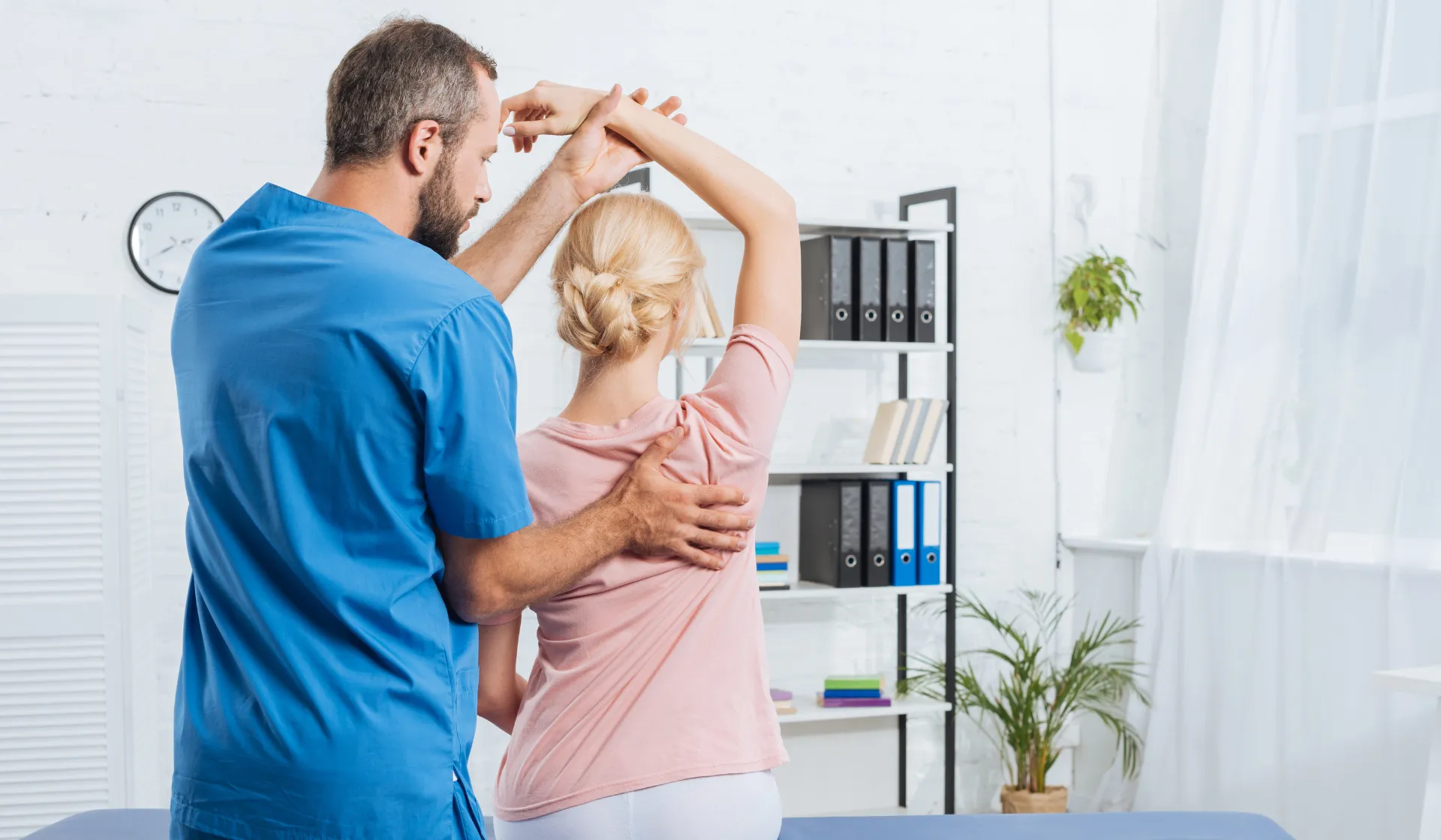 Happy chiropractor and patient during consultation discussing treatment plan